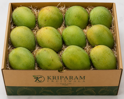 A cardboard box of 12 langada mangoes from banaras nestled in shredded paper, with the brand name 'Kriparam Fruitwala' printed on the front.