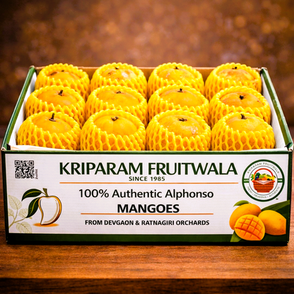 Box of Kriparam Fruitwala alphonso mangoes on a wooden surface with a blurred background